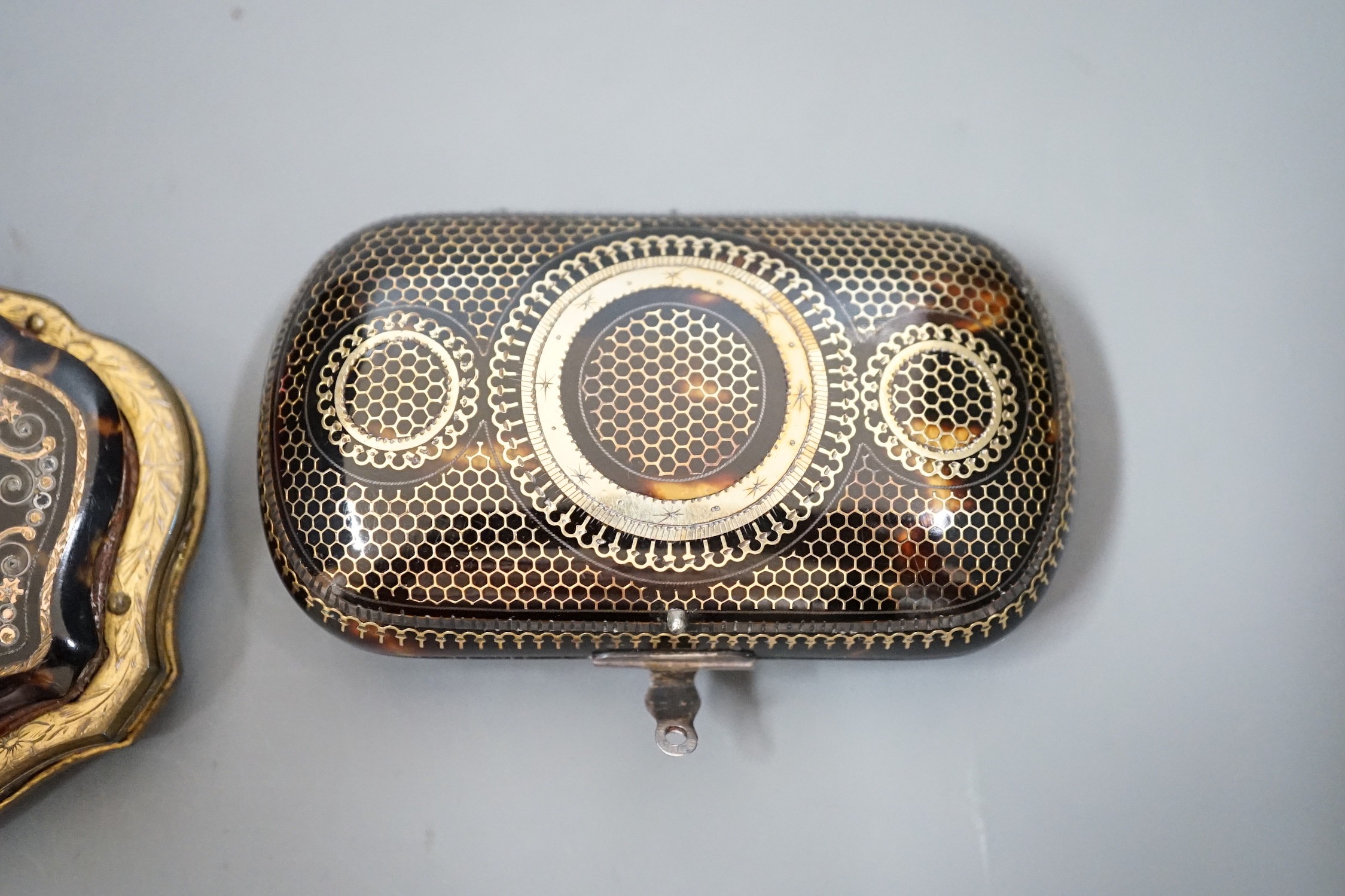 A 19th century finely worked tortoiseshell piqué work purse, with blue silk lining and a similar git metal edged piqué work purse